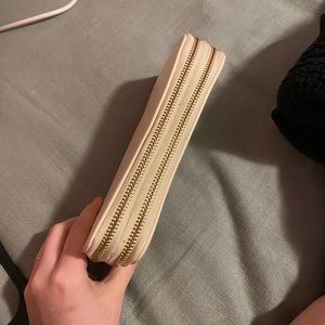 White wallet with two compartments for cards, cash, and change